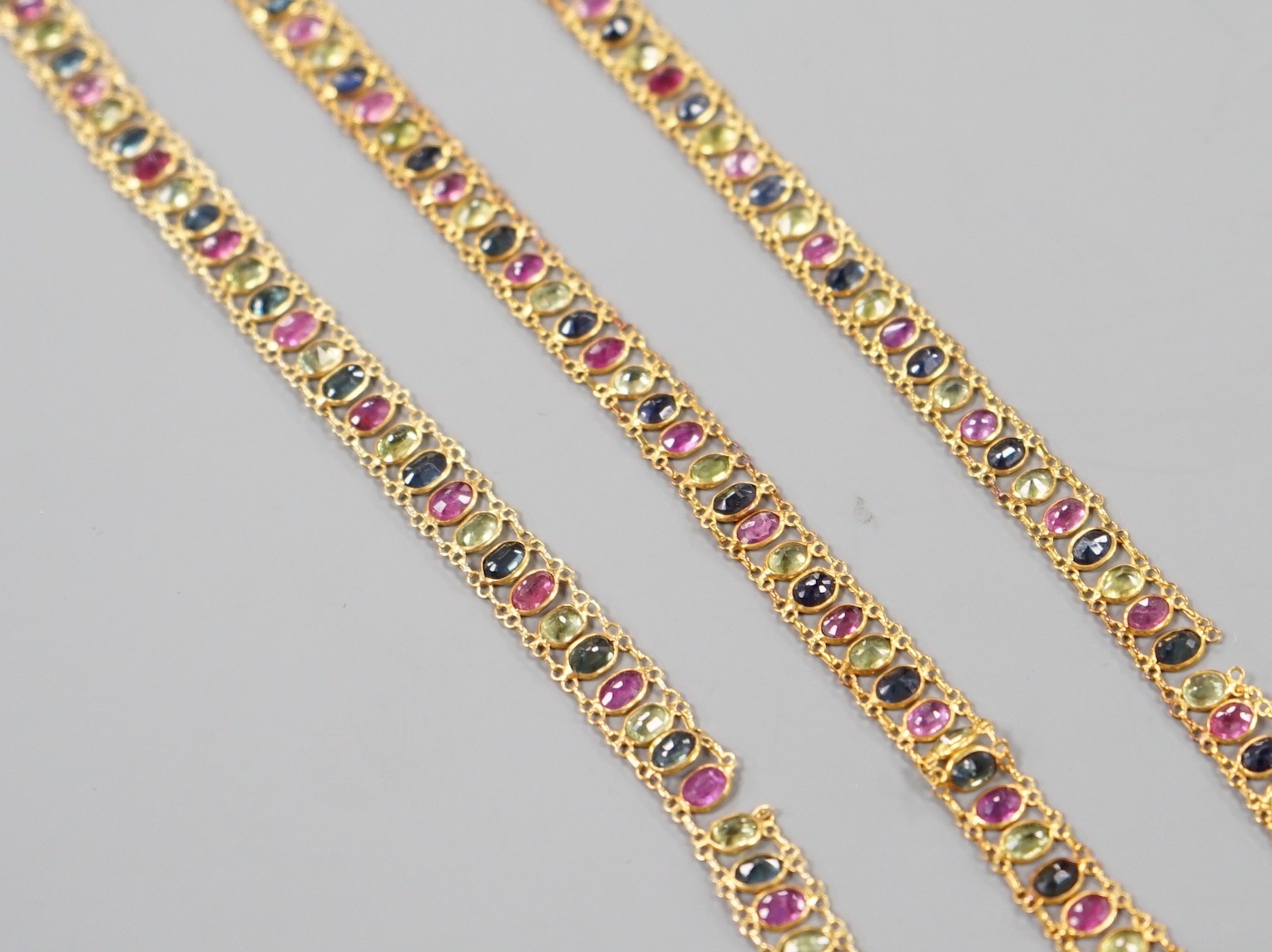 A continental yellow metal and multi gem necklace, 39cm and matching bracelet, 17cm, gross weight 12.1 grams. - two links a.f.